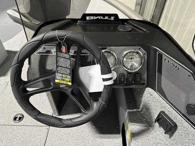 Slide: The Image of 2024 Lund 1875 Alaskan SS boat dashboard with steering wheel and gauges. - 14