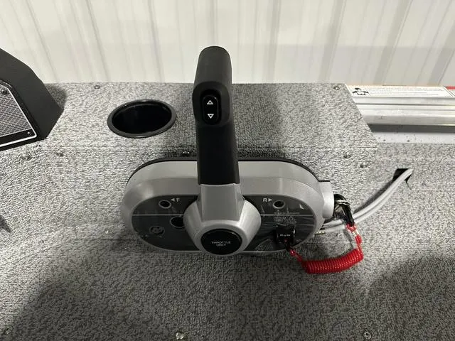 Slide: The Image of 2024 Lund 1875 Alaskan SS boat throttle control on textured surface. - 17