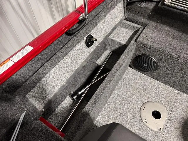 Slide: The Image of 2024 Lund 1650 Rebel XL Sport boat interior storage compartment and seating area. - 11