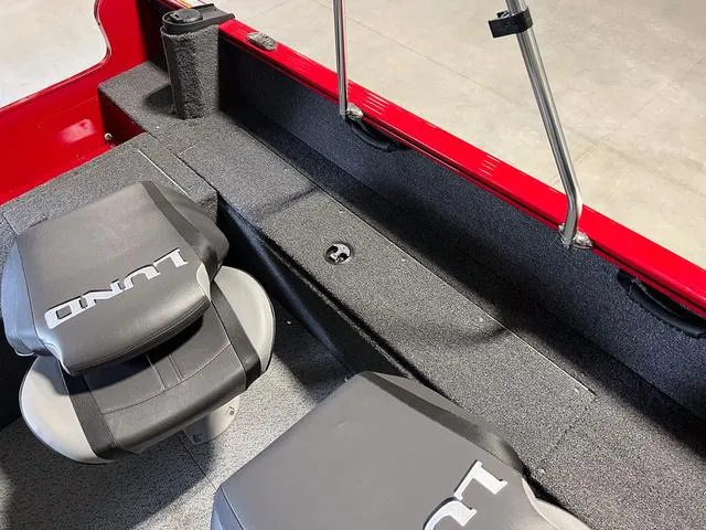 Slide: The Image of 2024 Lund 1650 Rebel XL Sport interior with seating and storage. - 12