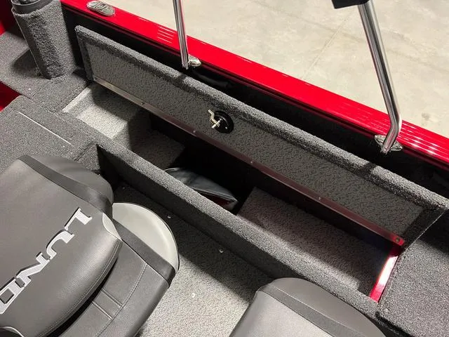 Slide: The Image of 2024 Lund 1650 Rebel XL Sport interior storage compartment and seating. - 13