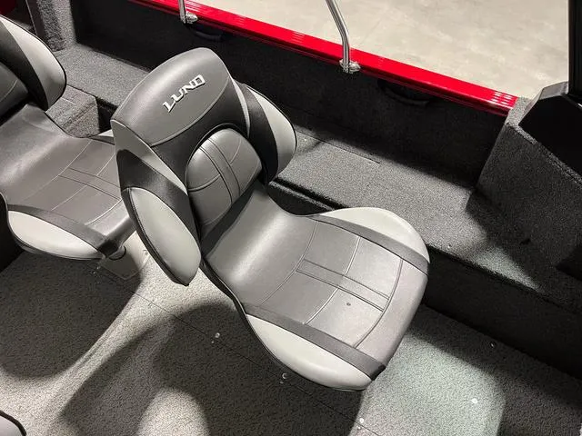 Slide: The Image of 2024 Lund 1650 Rebel XL Sport boat interior with comfortable seating. - 15