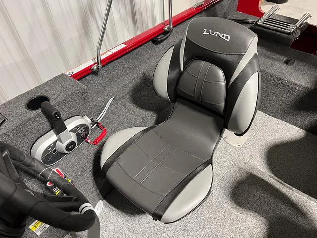 Slide: The Image of 2024 Lund 1650 Rebel XL Sport boat interior with black and gray captain's chair. - 18