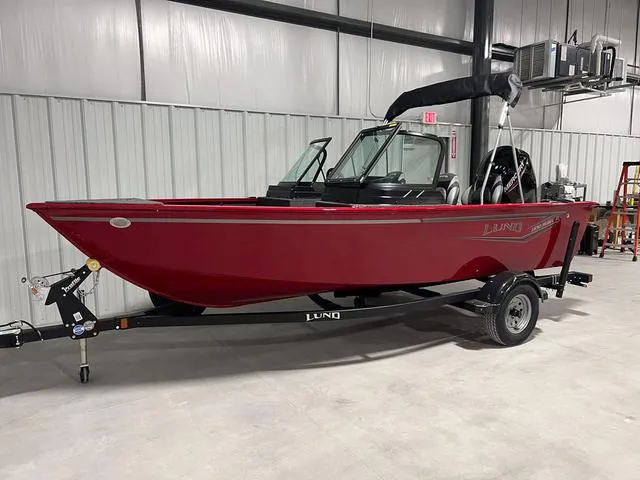 Slide: The Image of 2024 Lund 1650 Rebel XL Sport boat in a showroom. - 2