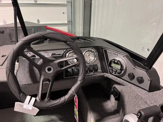 Slide: The Image of 2024 Lund 1650 Rebel XL Sport boat dashboard with steering wheel and instrument panel. - 20