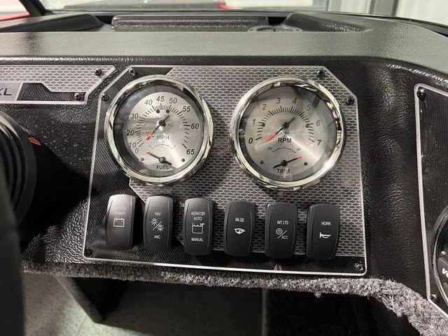 Slide: The Image of 2024 Lund 1650 Rebel XL Sport dashboard with speedometer, tachometer, and control switches. - 21