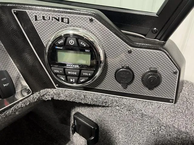 Slide: The Image of 2024 Lund 1650 Rebel XL Sport boat dashboard with Kicker audio system. - 22