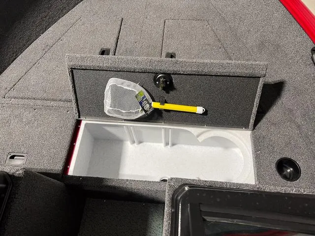 Slide: The Image of 2024 Lund 1650 Rebel XL Sport boat storage compartment with fishing net. - 25