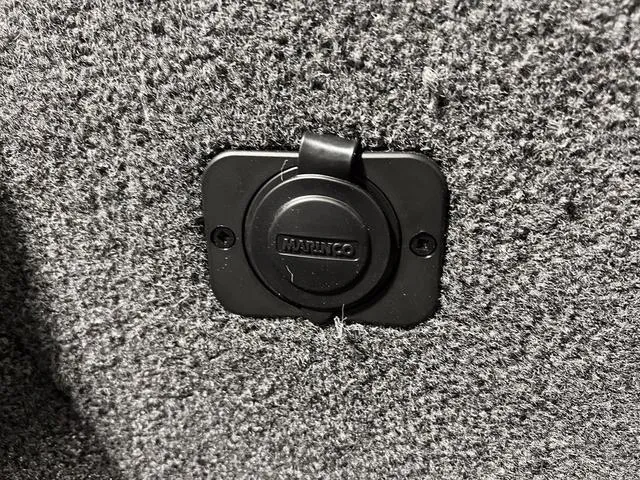 Slide: The Image of Close-up of a 2024 Lund 1650 Rebel XL Sport boat's Marinco power outlet. - 30