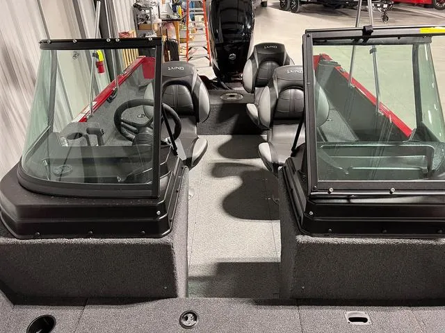 Slide: The Image of 2024 Lund 1650 Rebel XL Sport boat interior with dual consoles and seating. - 31