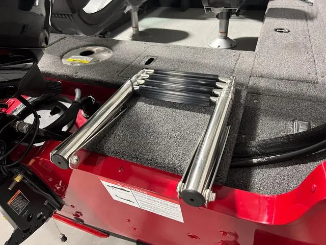 Slide: The Image of 2024 Lund 1650 Rebel XL Sport boat with folded ladder on deck. - 5