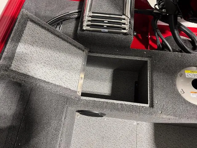 Slide: The Image of 2024 Lund 1650 Rebel XL Sport boat storage compartment and ladder. - 8