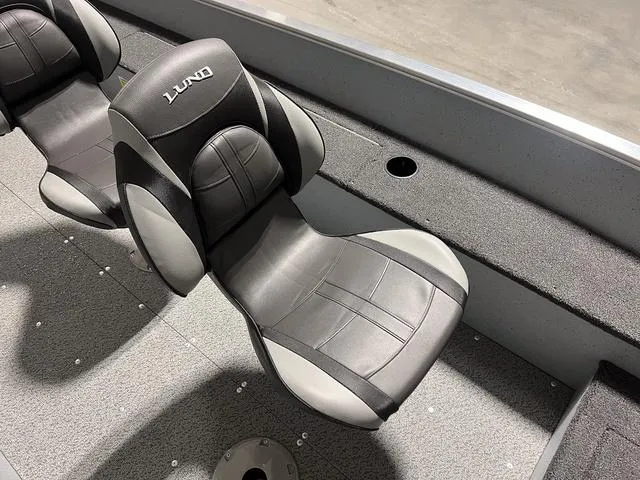 Slide: The Image of 2024 Lund 1600 Fury Tiller boat seats, black and gray upholstery. - 11