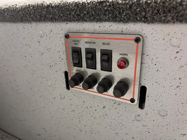 Slide: The Image of Control panel of 2024 Lund 1600 Fury Tiller boat with switches for lights, aerator, bilge, and horn. - 14