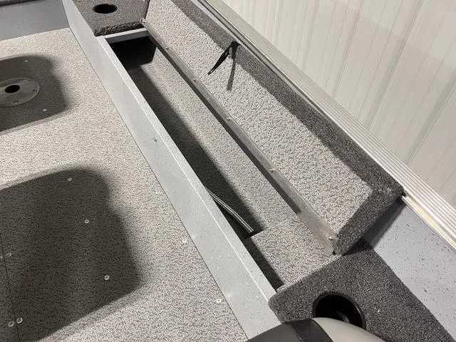 Slide: The Image of 2024 Lund 1600 Fury Tiller boat interior with storage compartment. - 15