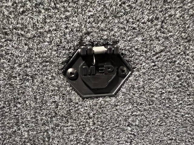 Slide: The Image of Close-up of a 2024 Lund 1600 Fury Tiller boat's carpeted surface with MEP latch. - 17