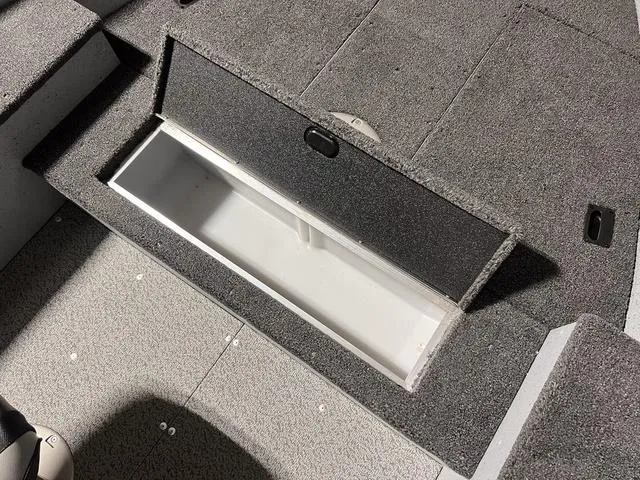 Slide: The Image of 2024 Lund 1600 Fury Tiller boat storage compartment with open lid. - 19
