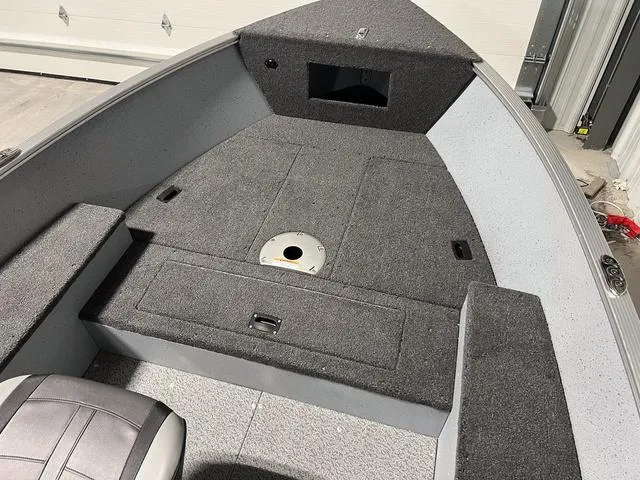 Slide: The Image of 2024 Lund 1600 Fury Tiller boat interior with storage compartments and seating. - 20