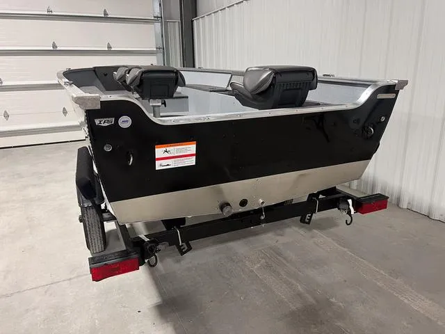 Slide: The Image of 2024 Lund 1600 Fury Tiller boat in a garage, rear view. - 3