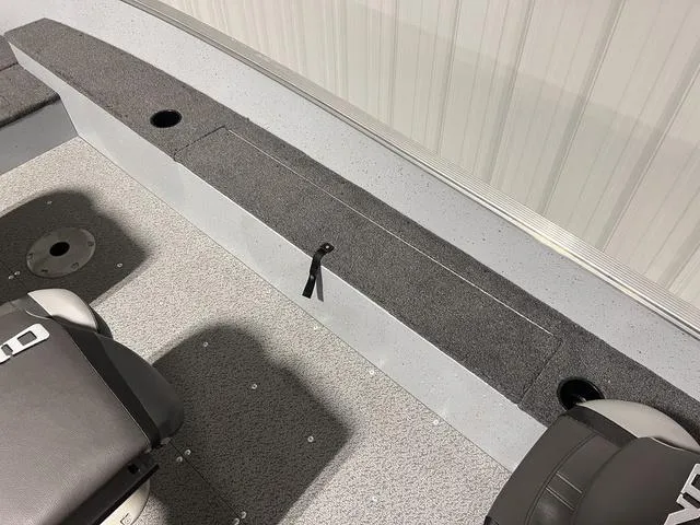 Slide: The Image of 2024 Lund 1600 Fury Tiller boat interior with seating and storage compartments. - 4