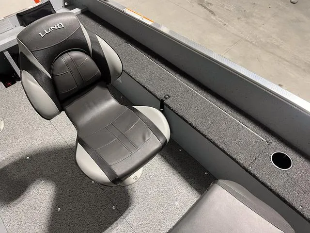 Slide: The Image of 2024 Lund 1600 Fury Tiller boat interior with black and gray seating. - 5