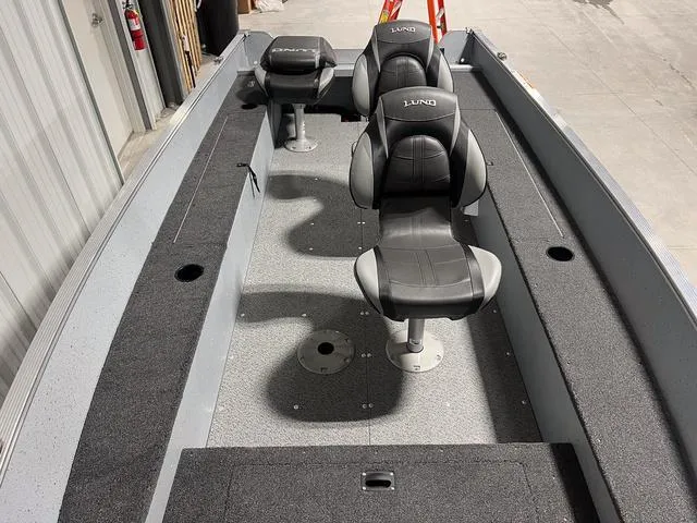 Slide: The Image of 2024 Lund 1600 Fury Tiller boat interior with three black seats. - 9