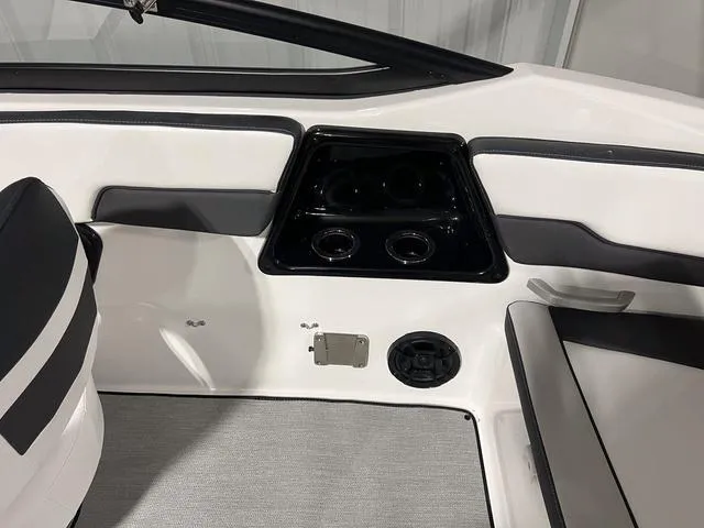 Slide: The Image of Interior of 2024 Yamaha Boats SX195, featuring cup holders and seating area. - 12