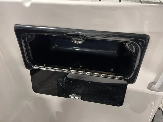 Slide: The Image of Open storage compartment on a 2024 Yamaha Boats SX195. - 15