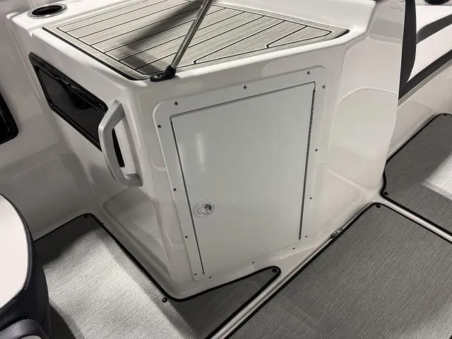 Slide: The Image of 2024 Yamaha Boats SX195 interior storage compartment and seating area. - 16