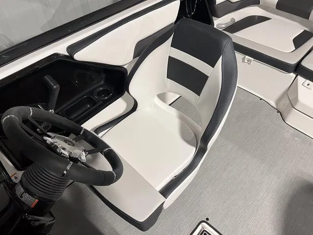 Slide: The Image of 2024 Yamaha Boats SX195 interior, featuring a sleek captain's chair and modern steering console. - 18