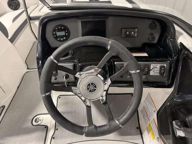 Slide: The Image of 2024 Yamaha Boats SX195 steering wheel and dashboard controls. - 19