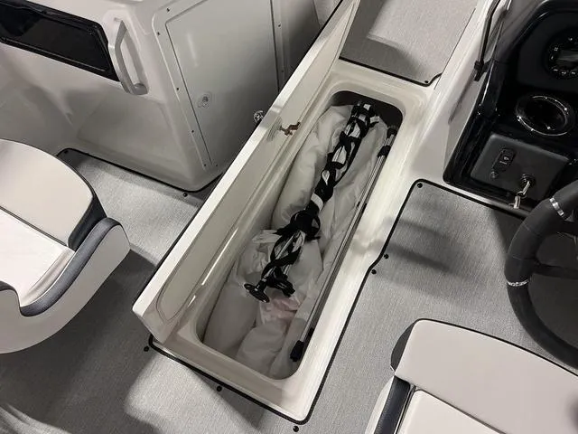 Slide: The Image of 2024 Yamaha Boats SX195 interior storage compartment with gear. - 23