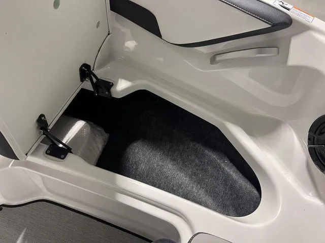 Slide: The Image of 2024 Yamaha Boats SX195 storage compartment with open hatch. - 26