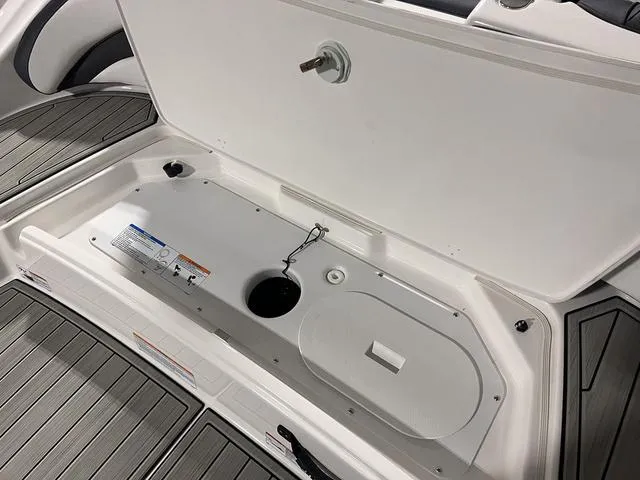 Slide: The Image of 2024 Yamaha Boats SX195 storage compartment with open hatch. - 7