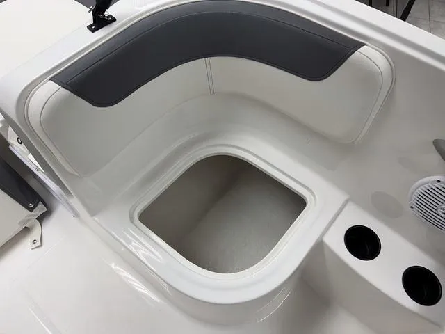 Slide: The Image of 2024 Bayliner E16 LTD boat interior seating and storage compartment. - 12