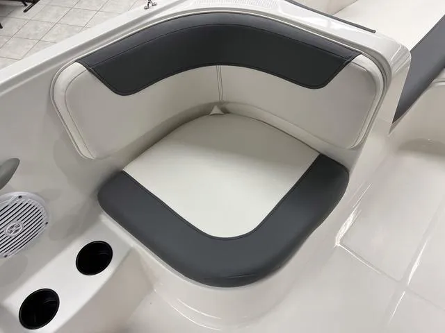 Slide: The Image of 2024 Bayliner E16 LTD boat interior seating with cup holders. - 13