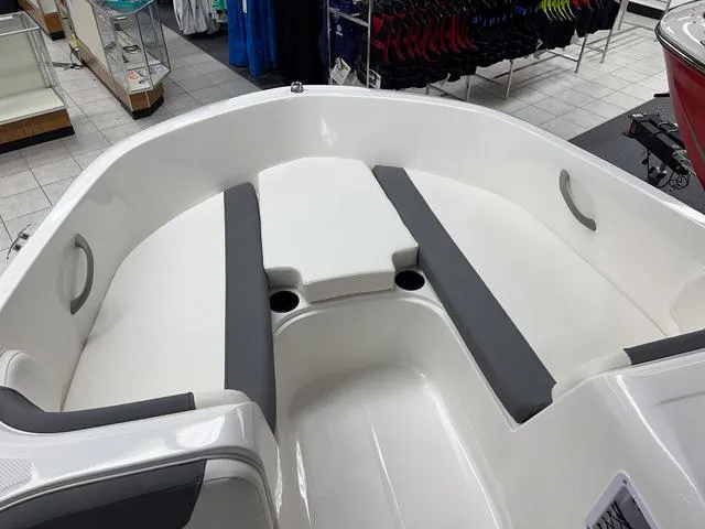 Slide: The Image of 2024 Bayliner E16 LTD boat interior with white and gray seating. - 18