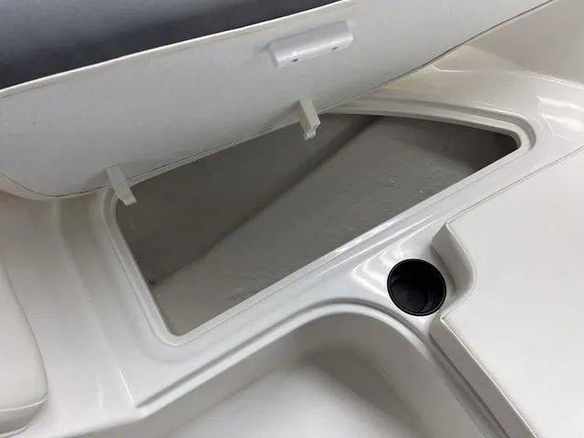 Slide: The Image of 2024 Bayliner E16 LTD boat storage compartment with cup holder. - 19