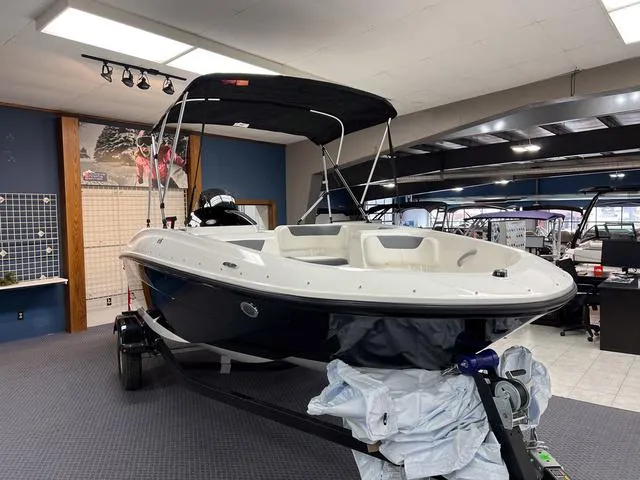 Slide: The Image of 2024 Bayliner E16 LTD boat on display in showroom. - 2
