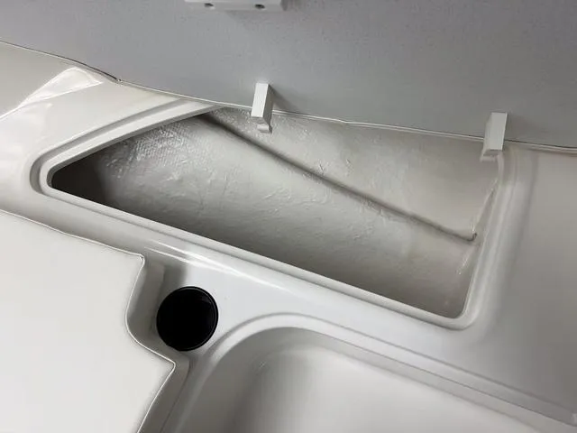 Slide: The Image of 2024 Bayliner E16 LTD storage compartment with open lid. - 20