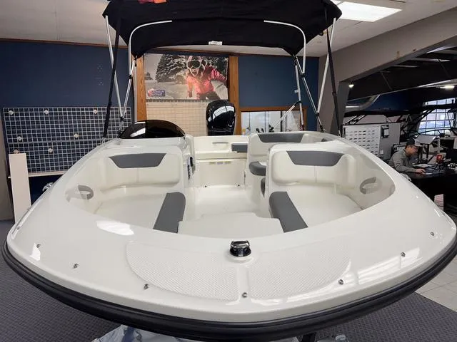 Slide: The Image of 2024 Bayliner E16 LTD boat interior with seating and canopy. - 3