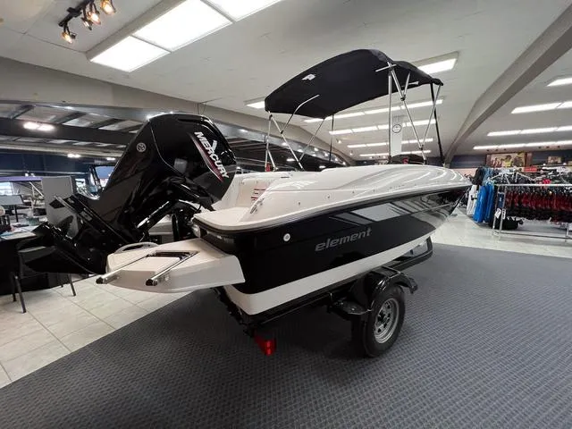 Slide: The Image of 2024 Bayliner E16 LTD boat on display in showroom with Mercury outboard motor. - 4
