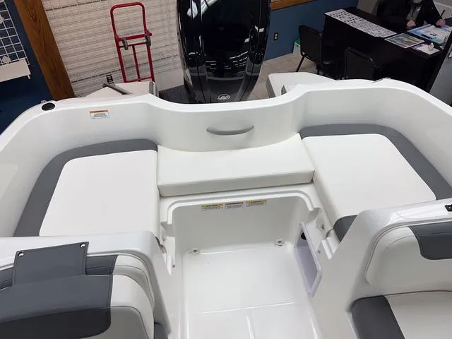 Slide: The Image of 2024 Bayliner E16 LTD boat interior with white and gray seating. - 8