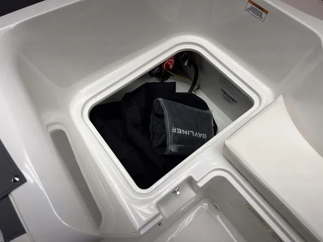 Slide: The Image of Storage compartment of 2024 Bayliner E16 LTD boat with Bayliner-branded bag inside. - 9