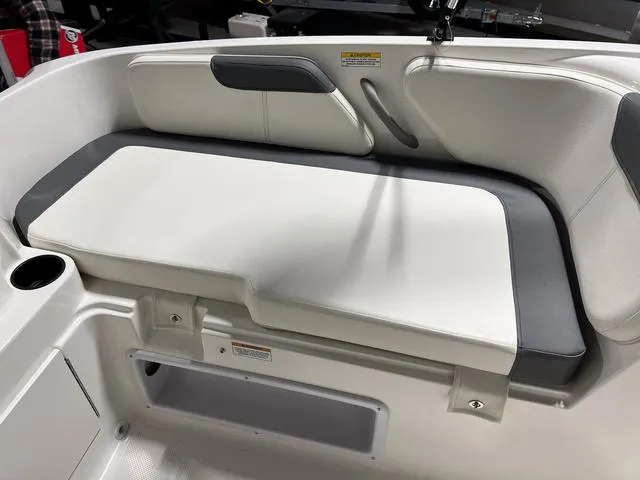 Slide: The Image of 2024 Bayliner E18 LTD boat interior seating with cup holder. - 12