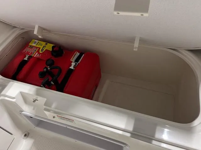 Slide: The Image of Storage compartment of 2024 Bayliner E18 LTD with red fuel tank. - 13