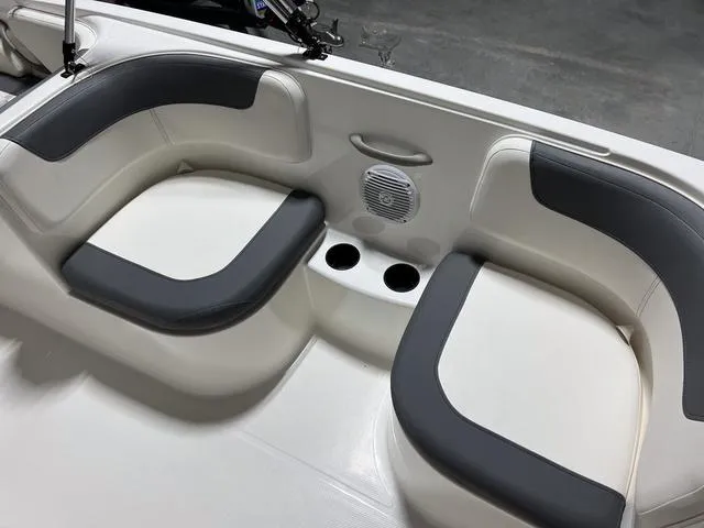 Slide: The Image of 2024 Bayliner E18 LTD boat interior seating with cup holders and speaker. - 14