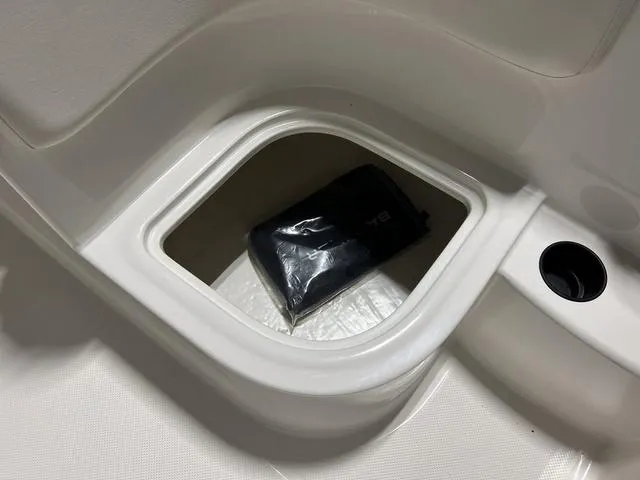 Slide: The Image of 2024 Bayliner E18 LTD storage compartment with black bag - 15