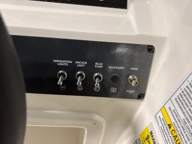 Slide: The Image of Control panel of 2024 Bayliner E18 LTD boat with switches for navigation lights, anchor light, bilge pump, accessory, and horn. - 20