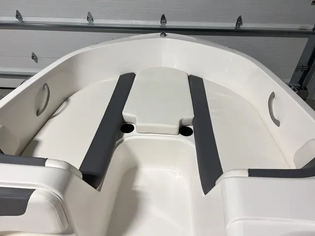 Slide: The Image of 2024 Bayliner E18 LTD boat interior with white and gray seating. - 21